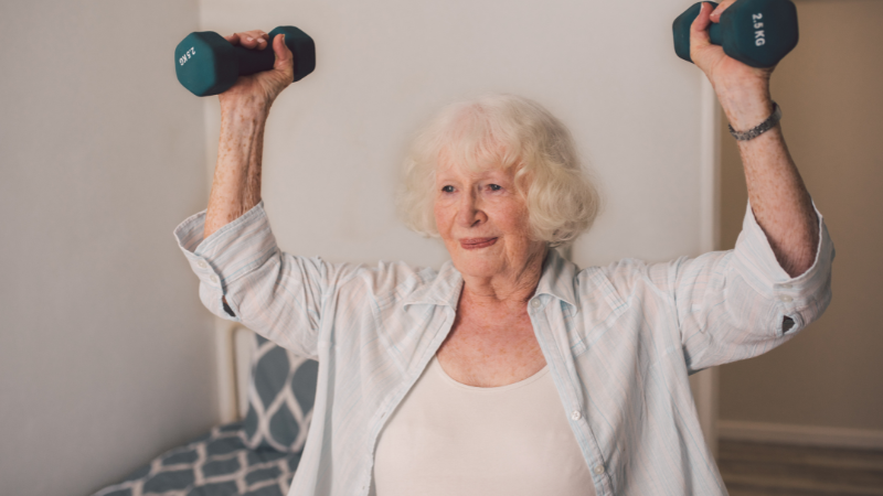 An elderly lady with dumbbells